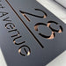 laser cut house number sign with rose gold mirror text