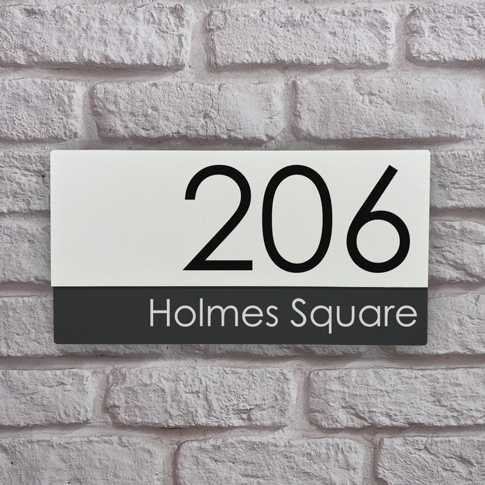 white and grey house number sign